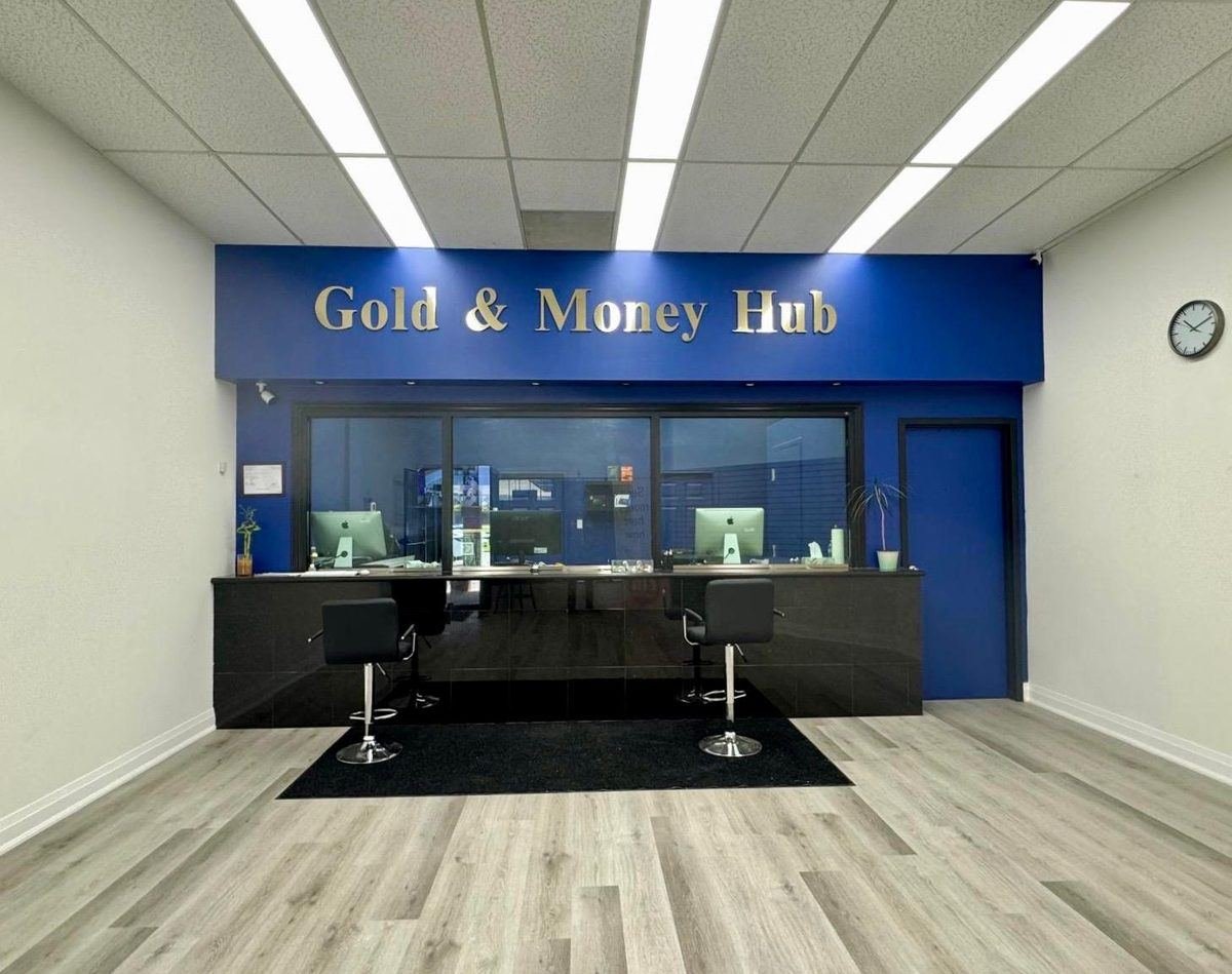 Inside Gold & Money Hub: the customer counter with the blue and gold Gold & Money Hub sign at our Mississauga store